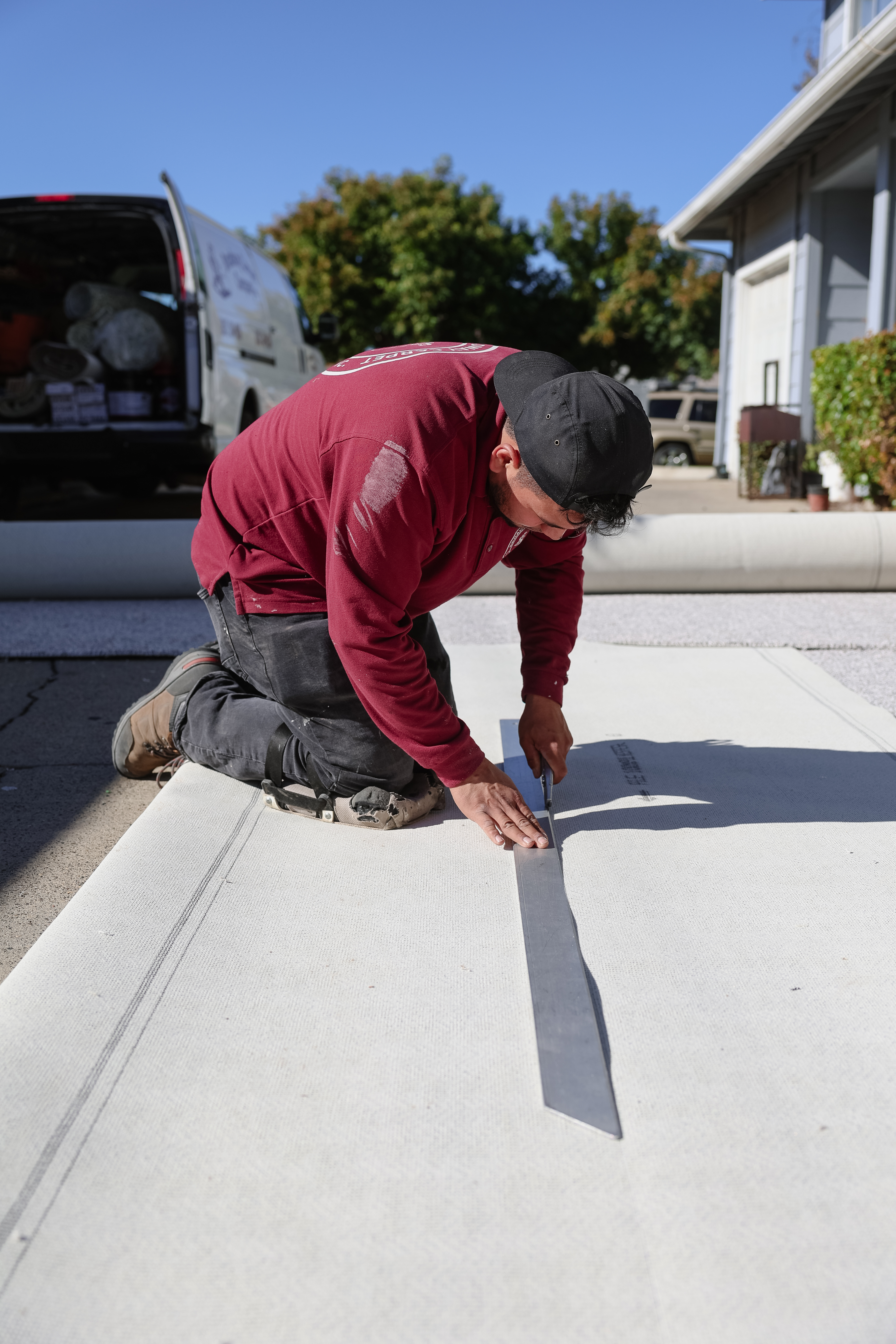 A Broadway Carpet installer carrying carpet